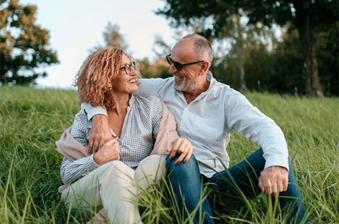 man and woman wearing glasses and smiling