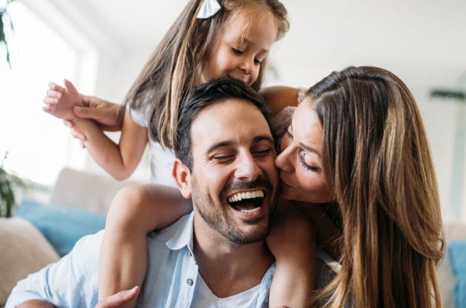 Man with Wife and Daughter smiling