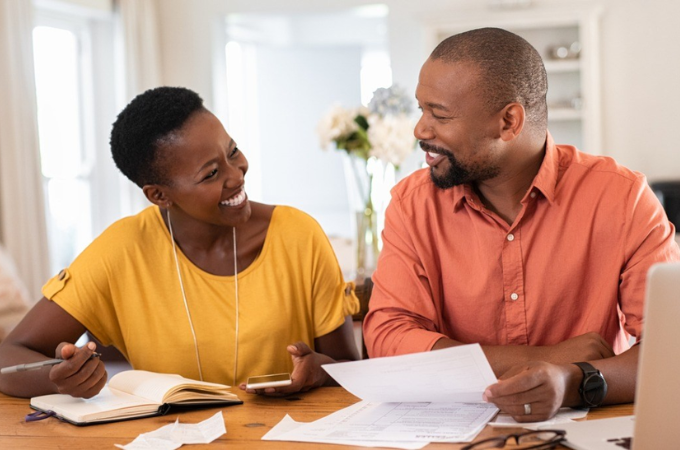 man and woman smiling at table