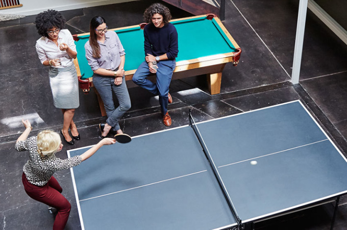 employees playing ping pong