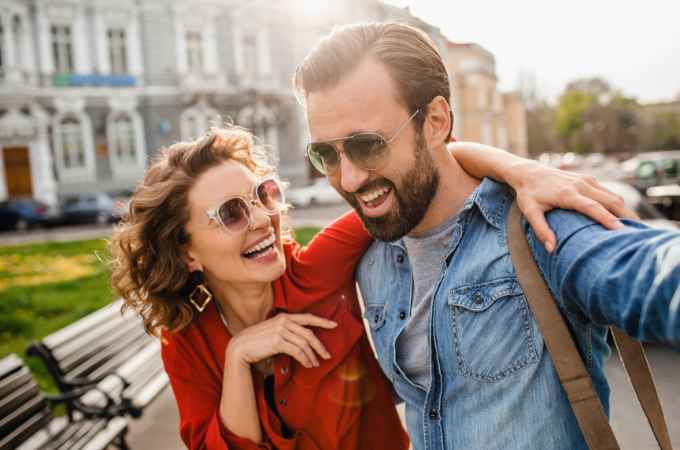 man and woman smiling wearing sunglasses