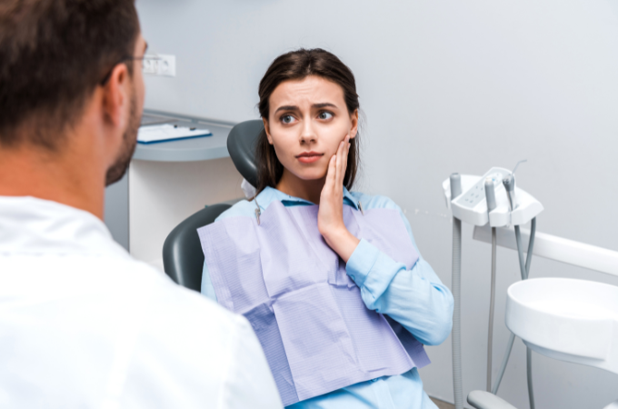 Woman holding jaw in pain